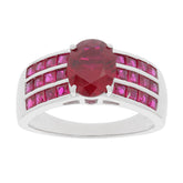 Oval red ruby sterling silver ring with ruby accent, featuring a central gemstone and dazzling side accents.